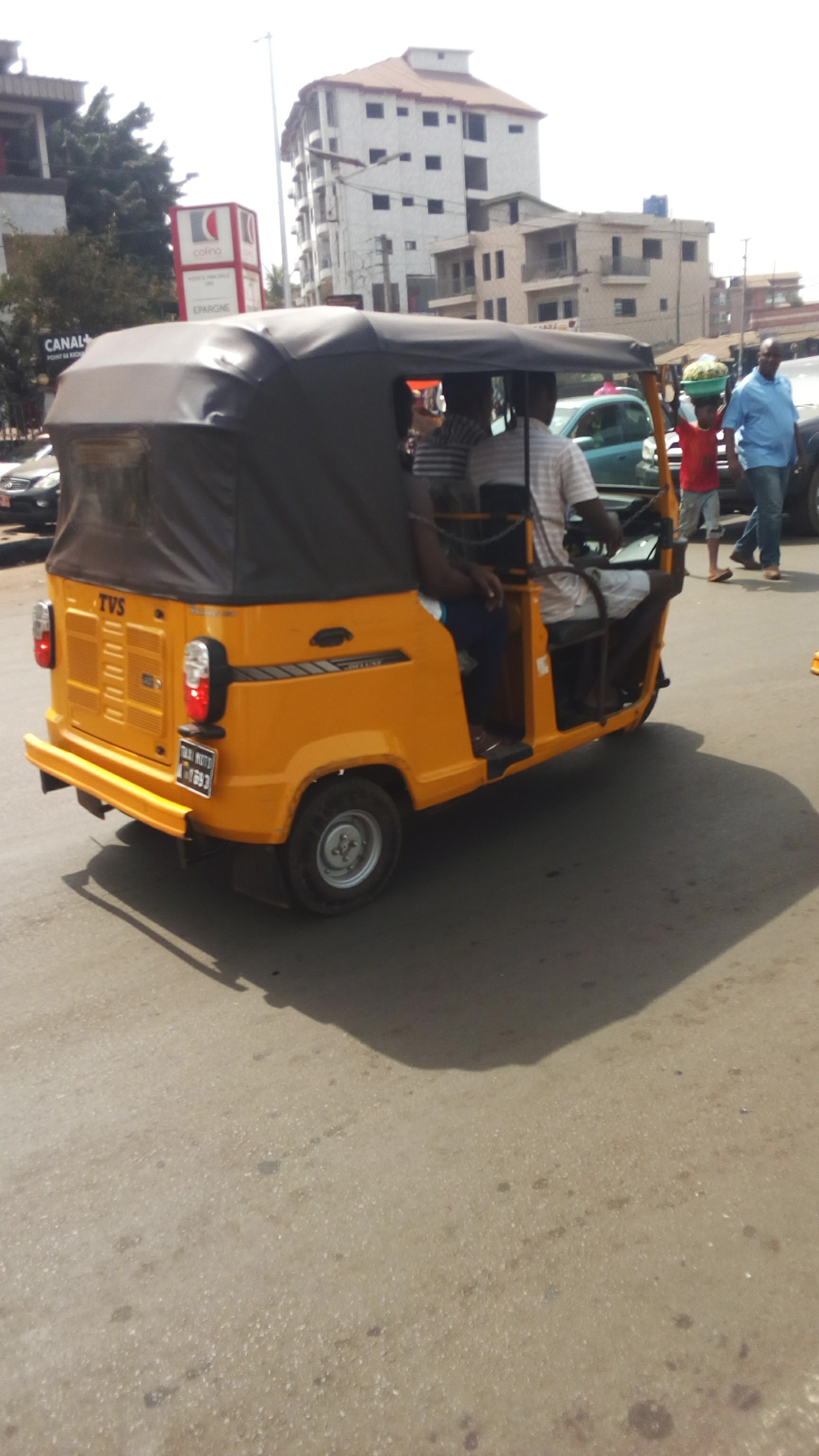 A moto-taxi on a busy shopping street in Conakry